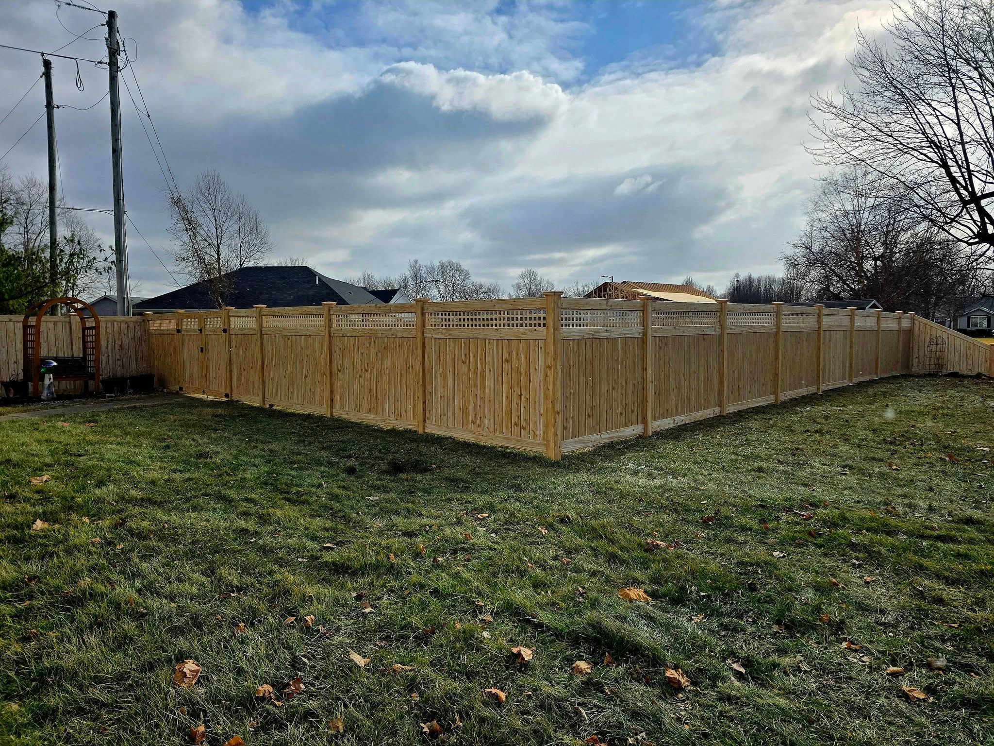 Eastern white cedar vinyl fence with lattice top enclosing a full backyard